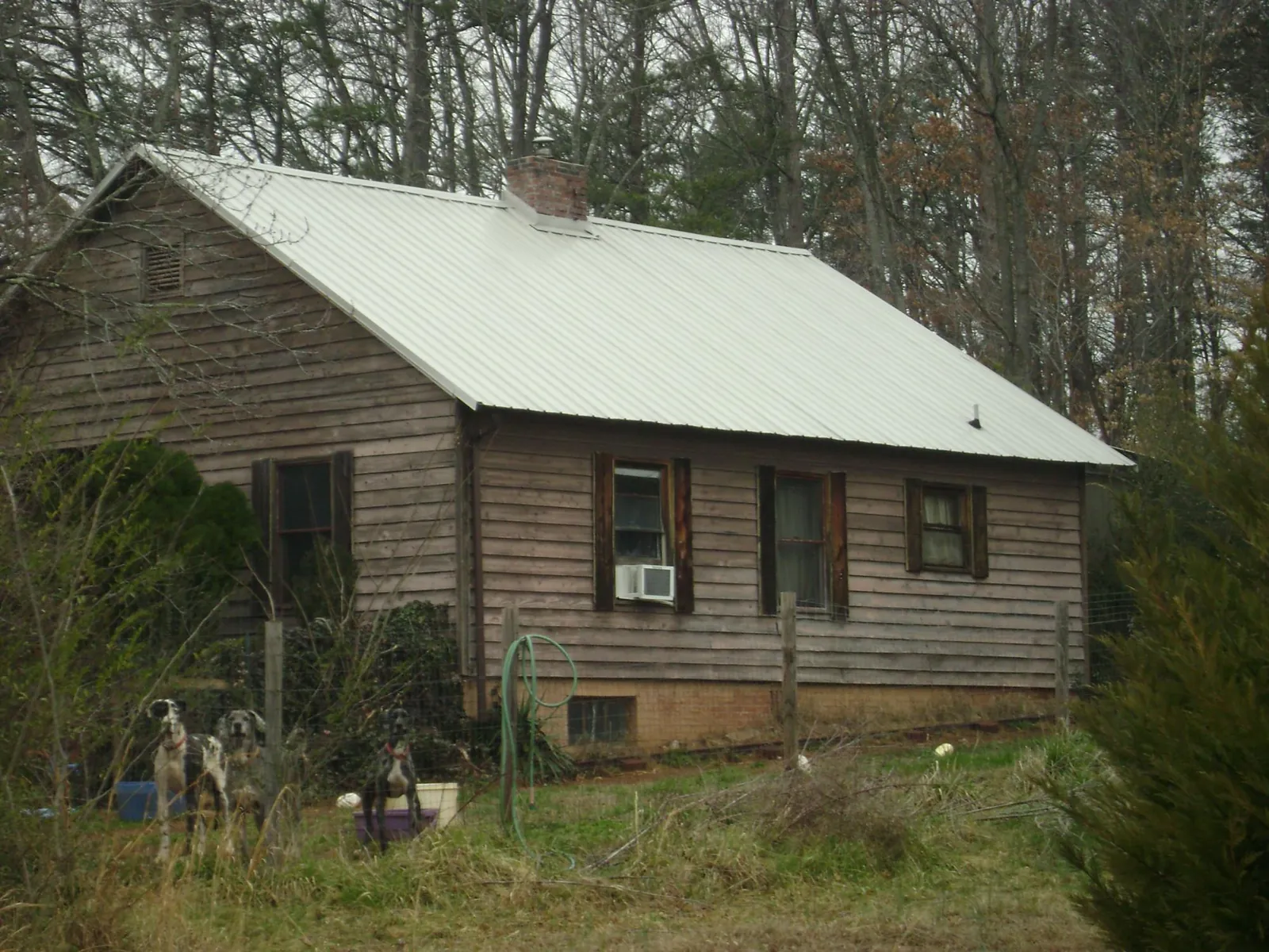 White metal roof on an old wood sided farmhouse, from a Metal Roof Installation job in State Center